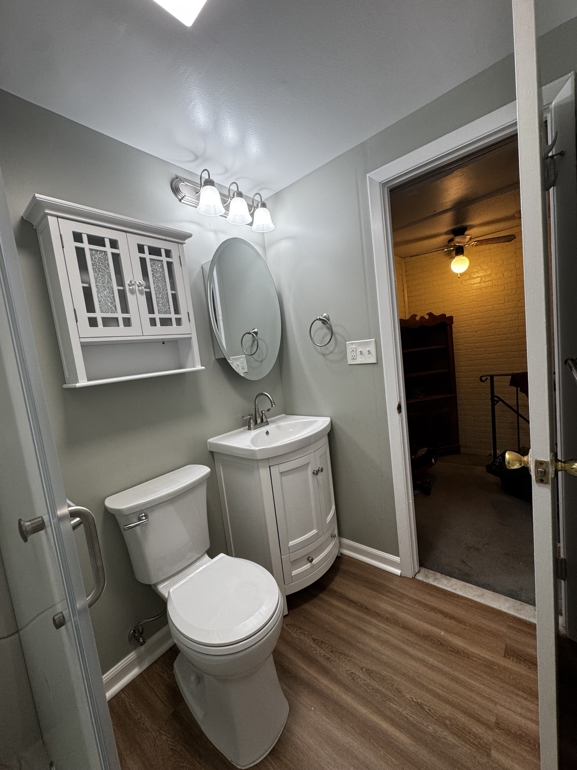 New vanity, mirror, lighting, and flooring in completed bathroom remodel